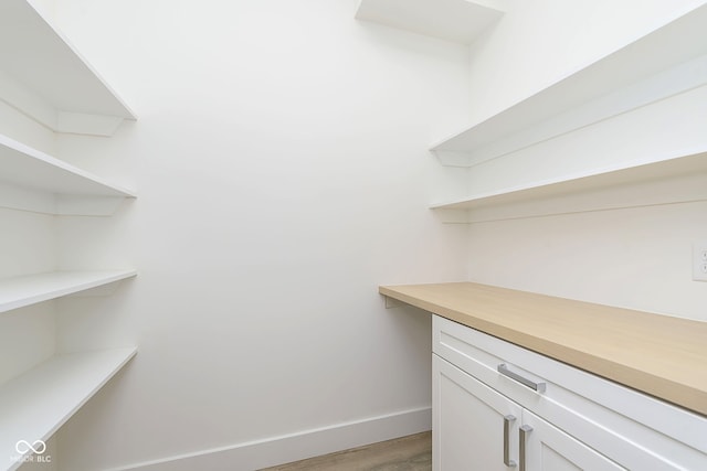 spacious closet featuring light hardwood / wood-style floors