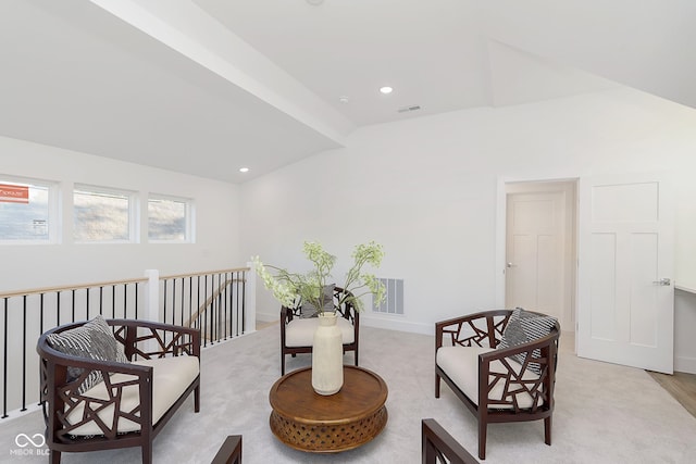 living area with vaulted ceiling with beams and light hardwood / wood-style flooring