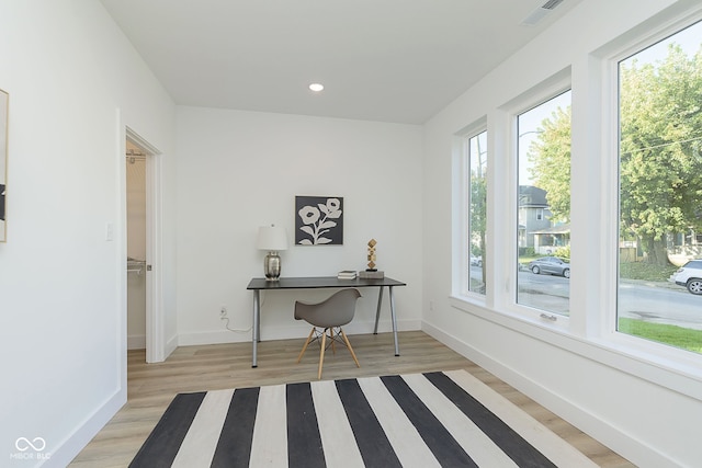 office with light wood-type flooring