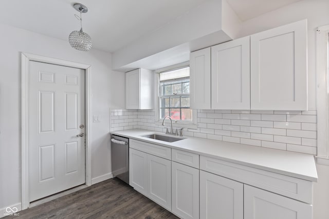 kitchen with dishwasher, decorative backsplash, sink, white cabinets, and pendant lighting