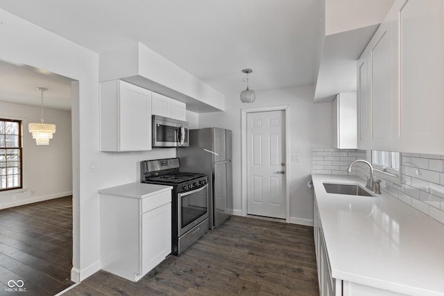 kitchen with white cabinetry, dark hardwood / wood-style flooring, stainless steel appliances, decorative backsplash, and sink