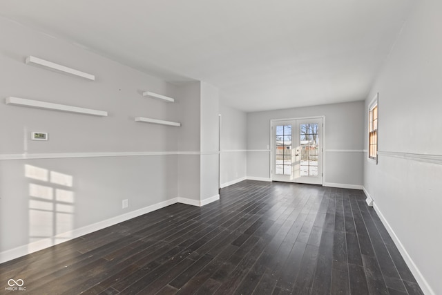 empty room with dark wood-type flooring and french doors