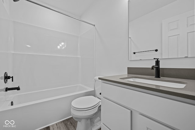 full bathroom with vanity, toilet, wood-type flooring, and bathing tub / shower combination