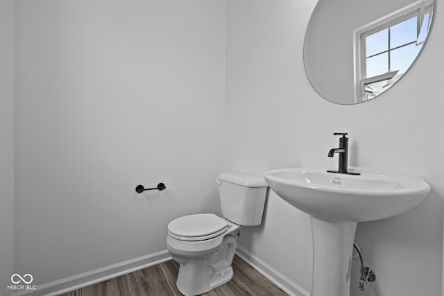 bathroom with toilet and hardwood / wood-style flooring