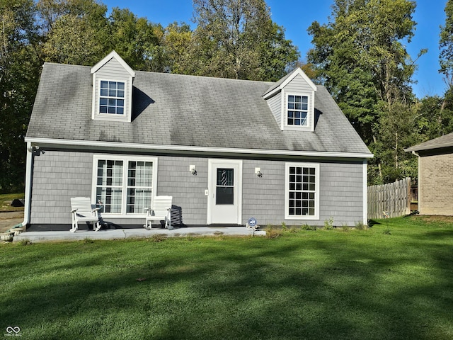 rear view of house with a patio area and a yard