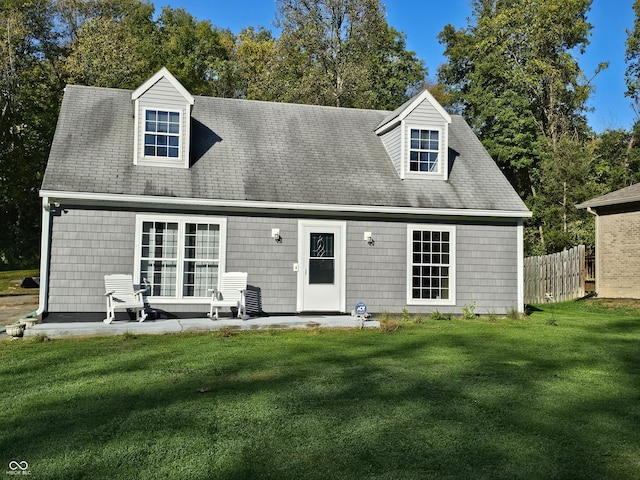 rear view of house with a lawn and a patio area