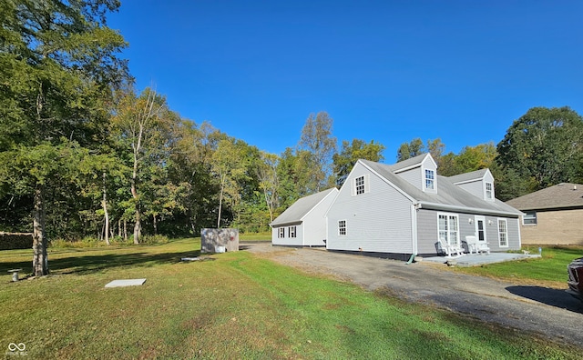 view of home's exterior featuring a patio area and a yard