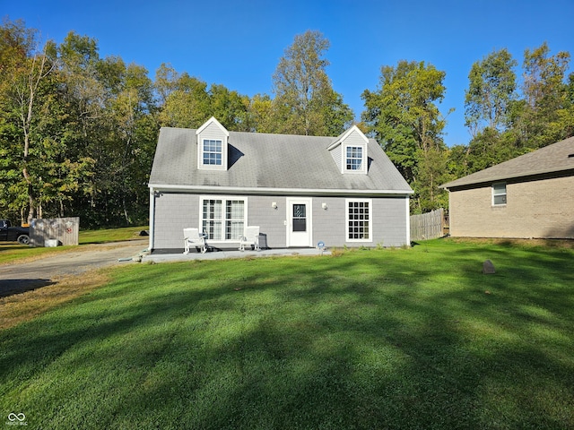 back of house with a lawn and a patio area