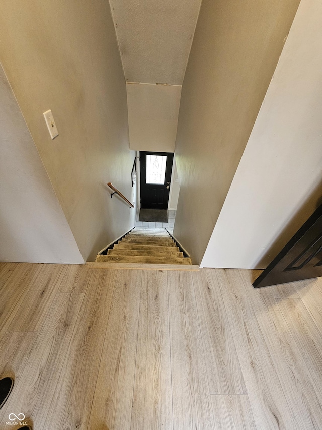 stairs with wood-type flooring