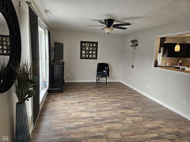 unfurnished room featuring hardwood / wood-style floors, a textured ceiling, and ceiling fan