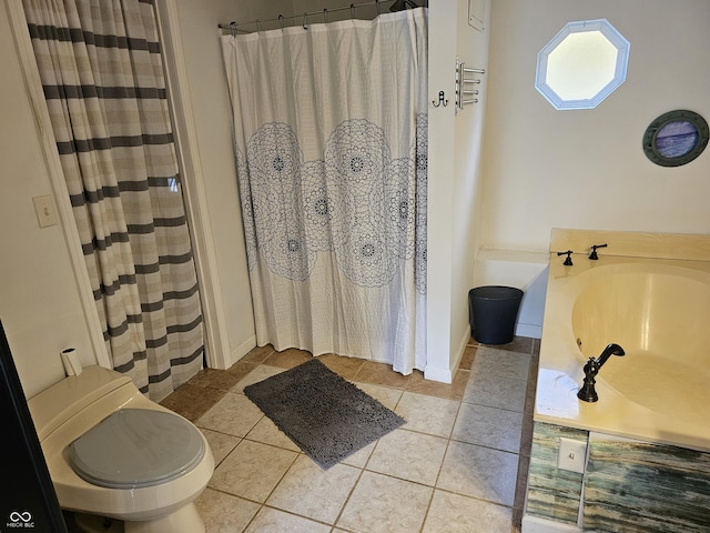 bathroom featuring toilet, tile patterned floors, and walk in shower