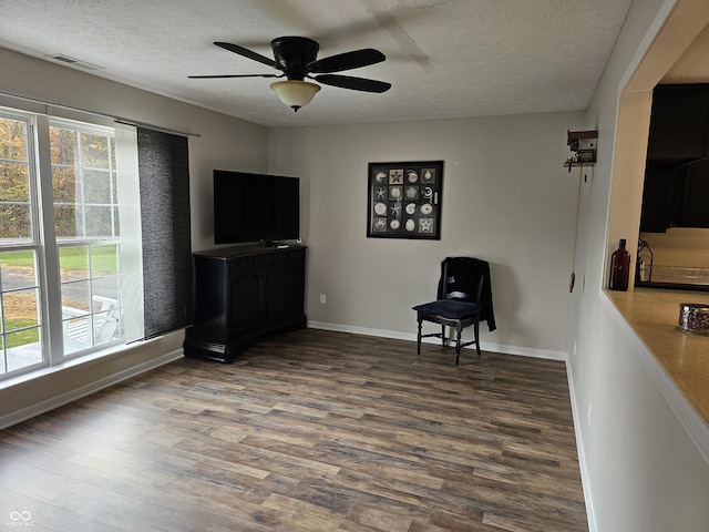 unfurnished room featuring a textured ceiling, hardwood / wood-style flooring, and ceiling fan