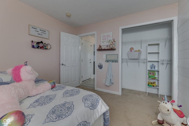 bedroom with carpet floors, a closet, and a textured ceiling