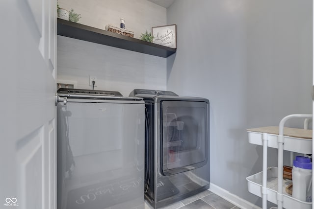 washroom featuring washer and dryer and light tile patterned floors