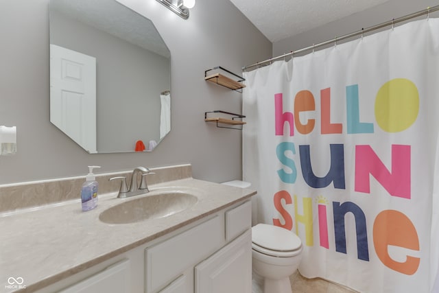 bathroom with vanity, walk in shower, tile patterned flooring, toilet, and a textured ceiling