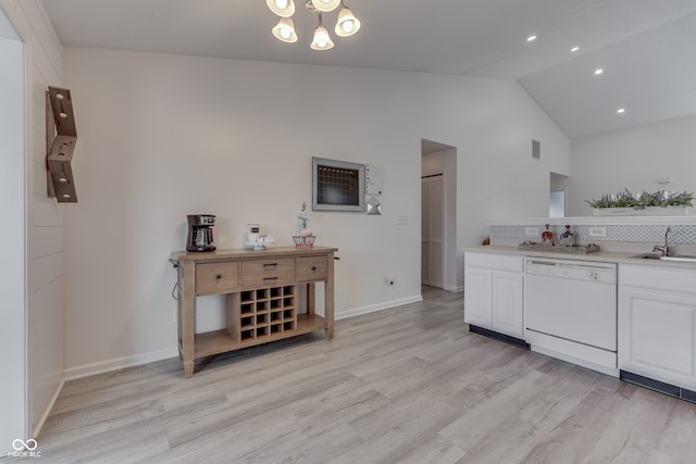 kitchen with white dishwasher, light wood-type flooring, high vaulted ceiling, and white cabinetry