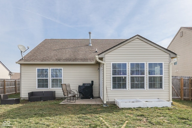 back of house featuring a lawn and a patio