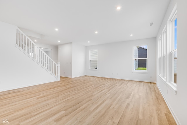 unfurnished living room featuring light hardwood / wood-style floors