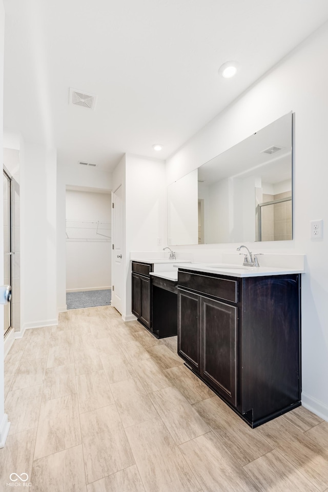 bathroom with vanity and walk in shower