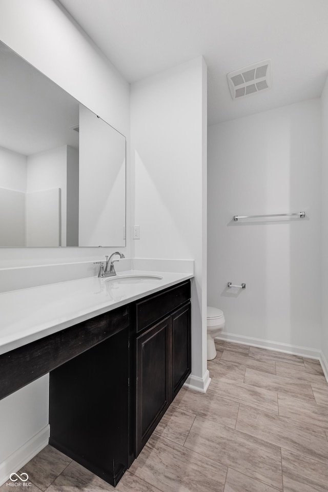 bathroom with vanity and toilet