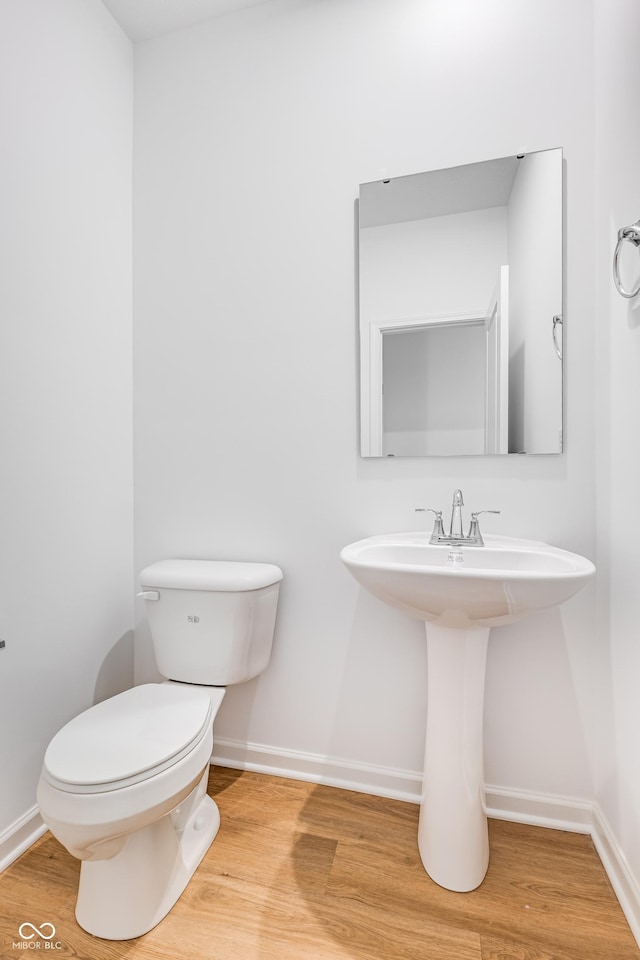 bathroom featuring hardwood / wood-style floors and toilet