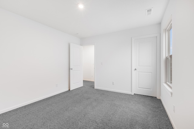 interior space featuring dark carpet