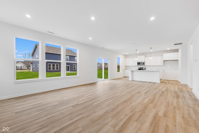 unfurnished living room featuring light hardwood / wood-style floors