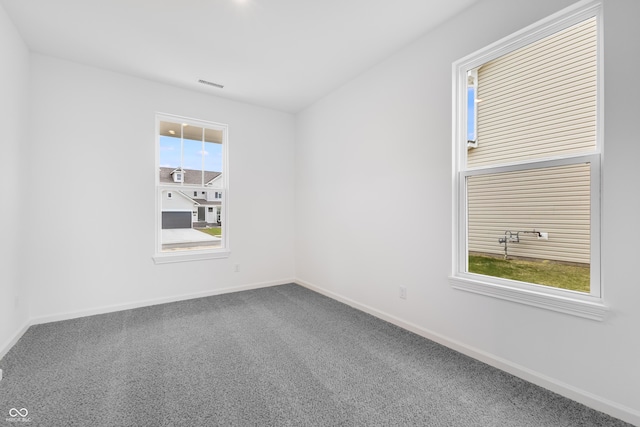 unfurnished room featuring carpet flooring