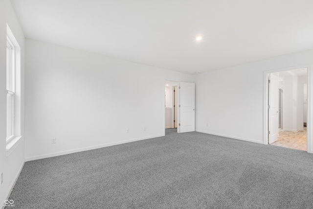 unfurnished room featuring light colored carpet