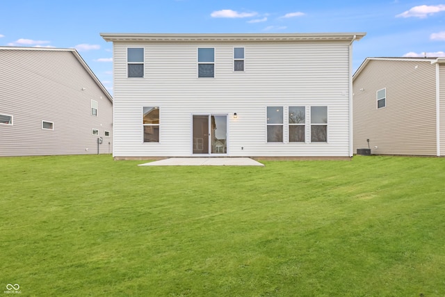 back of house with a patio area and a lawn