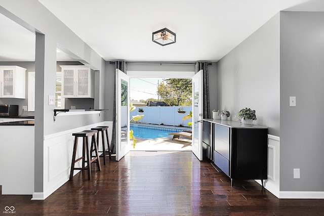 kitchen with dark hardwood / wood-style flooring and white cabinetry