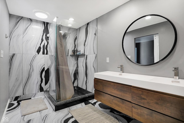 bathroom with vanity and tiled shower