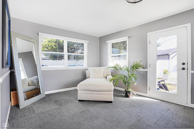 living area with dark colored carpet and a wealth of natural light