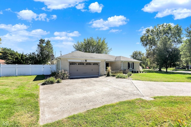 single story home featuring a garage and a front lawn