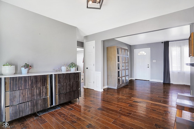 entryway with dark hardwood / wood-style flooring