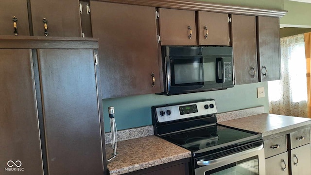 kitchen with refrigerator and stainless steel electric range oven