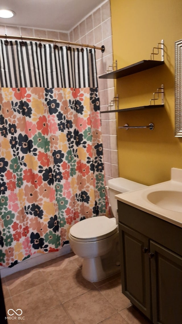 bathroom with a shower with curtain, vanity, tile patterned flooring, and toilet