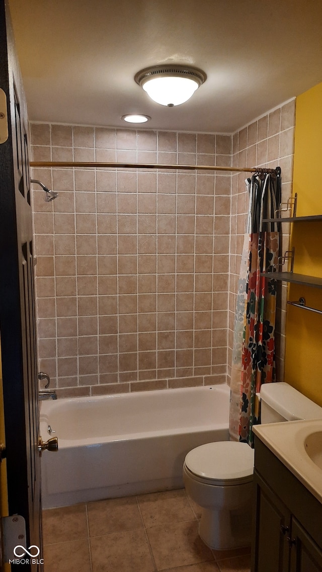 full bathroom featuring shower / bath combo with shower curtain, tile patterned floors, vanity, and toilet