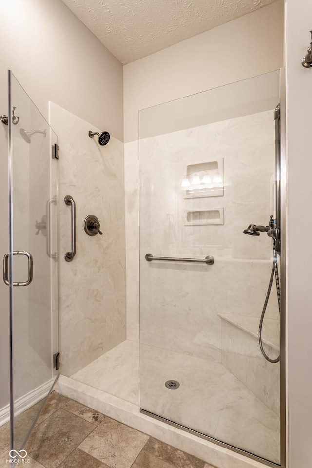 bathroom featuring a textured ceiling and walk in shower