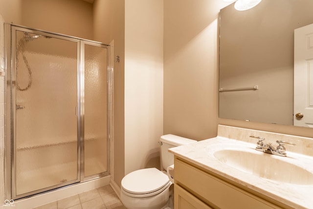 bathroom featuring an enclosed shower, vanity, tile patterned floors, and toilet