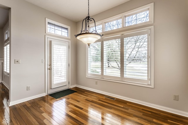 foyer featuring dark wood-type flooring and a wealth of natural light