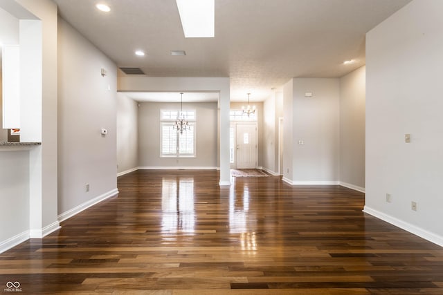 interior space featuring a notable chandelier and dark wood-type flooring