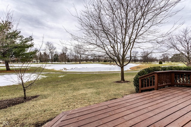 wooden terrace with a water view and a lawn