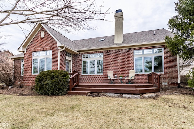 back of property with a wooden deck and a yard