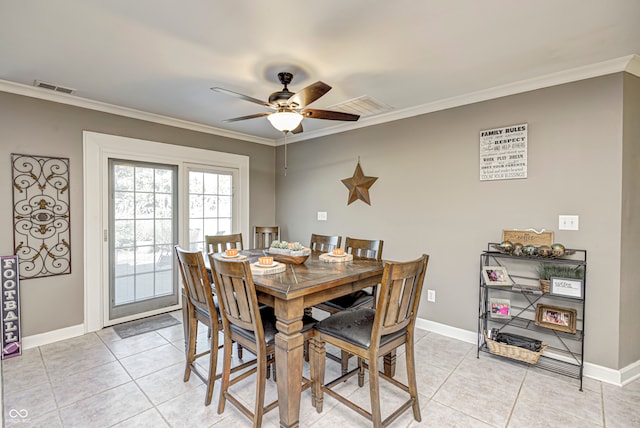 dining area featuring light tile patterned floors, ceiling fan, visible vents, and ornamental molding