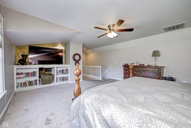 carpeted bedroom with vaulted ceiling, a ceiling fan, visible vents, and baseboards