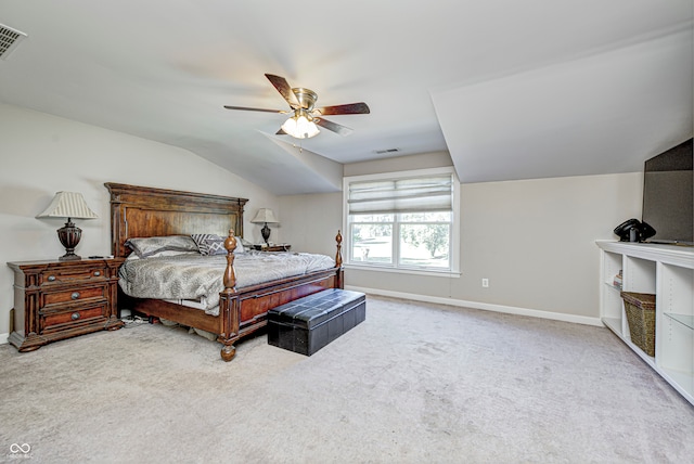 carpeted bedroom with lofted ceiling, baseboards, visible vents, and ceiling fan