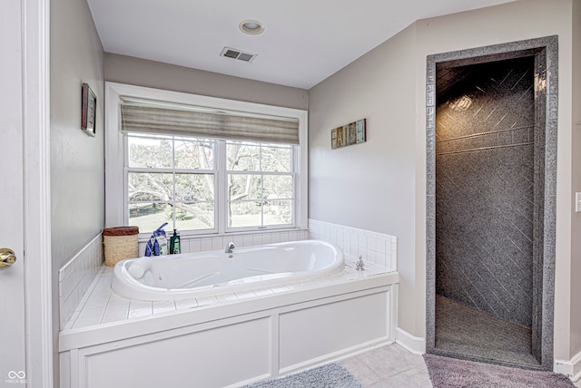 bathroom featuring a walk in shower, visible vents, a whirlpool tub, and tile patterned floors