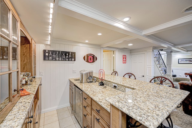 kitchen with beamed ceiling, light tile patterned flooring, a kitchen bar, and light stone countertops