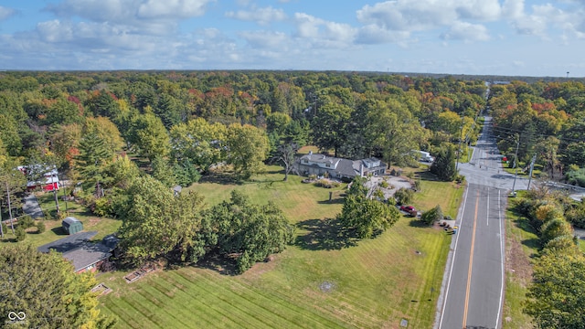 drone / aerial view with a wooded view